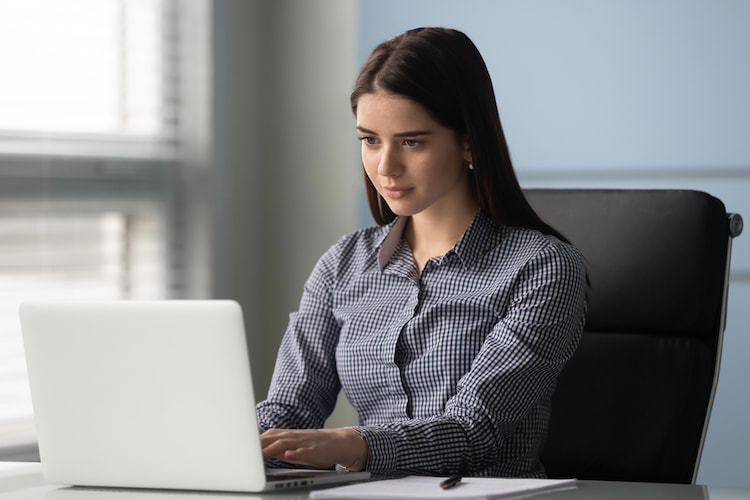A professional researcher analysing qualitative research data on her computer