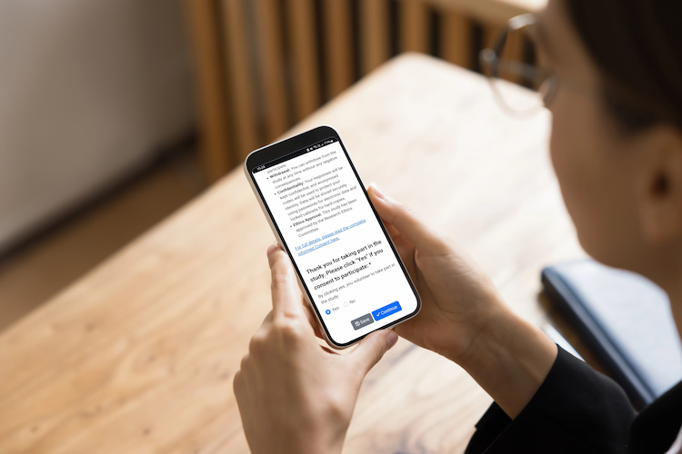 A businessperson looking at a survey on their phone