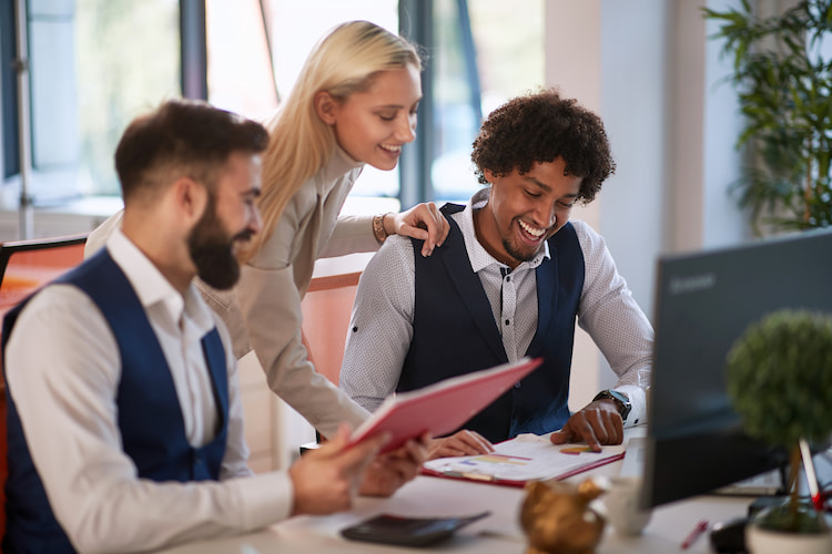 Satisfied employees working together to help each other